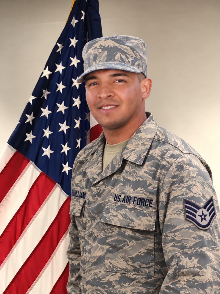 Alexis Guilliani, U.S. Air Force veteran and New Jersey real estate agent, wearing his military uniform beside the American flag.